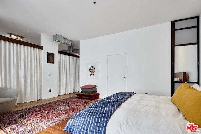 bedroom with wood-type flooring