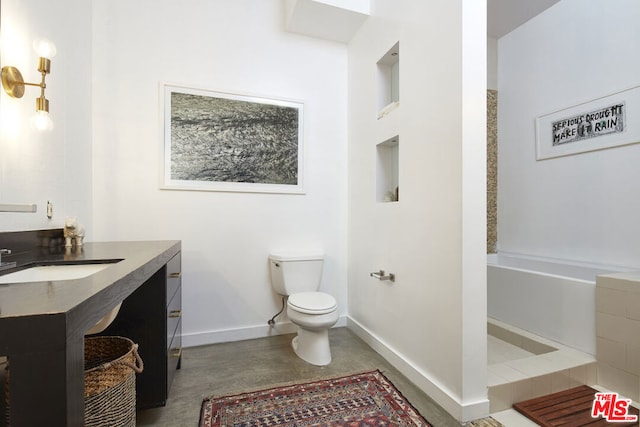 bathroom featuring concrete flooring, vanity, and toilet