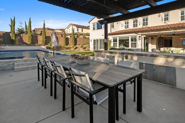 view of patio / terrace featuring a fenced in pool, a bar, and a pergola