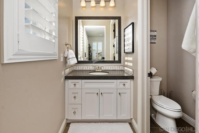 bathroom with vanity and toilet