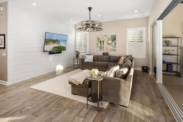 living room with a notable chandelier and wood-type flooring