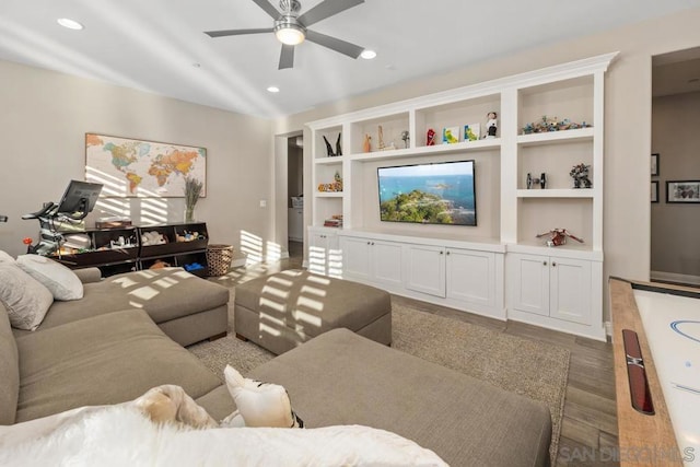 living room with ceiling fan, dark hardwood / wood-style flooring, and built in features