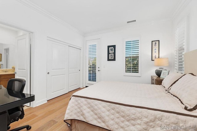 bedroom featuring ornamental molding, light hardwood / wood-style floors, and access to outside