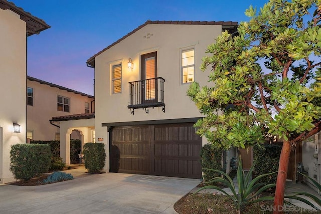 mediterranean / spanish house with a garage