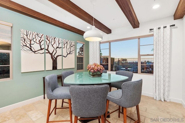 dining room featuring beamed ceiling