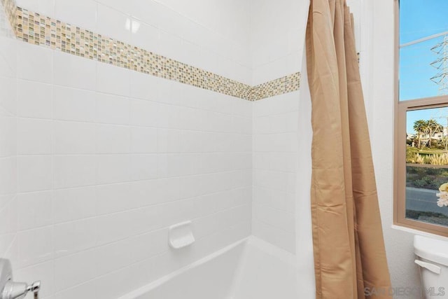 bathroom with curtained shower and toilet