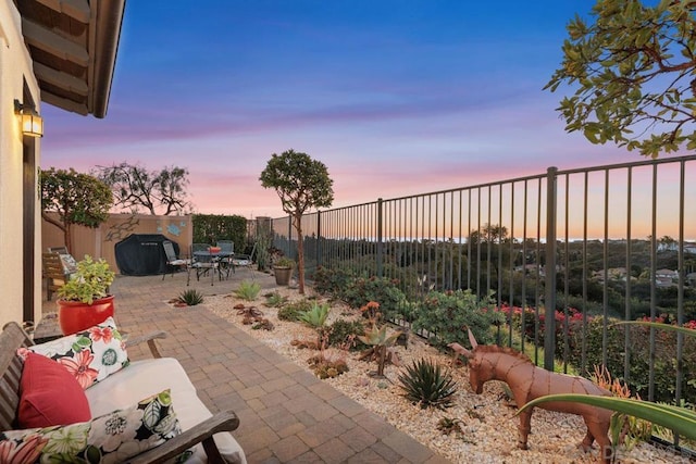 view of patio terrace at dusk