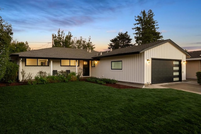 view of front of house with a garage and a lawn