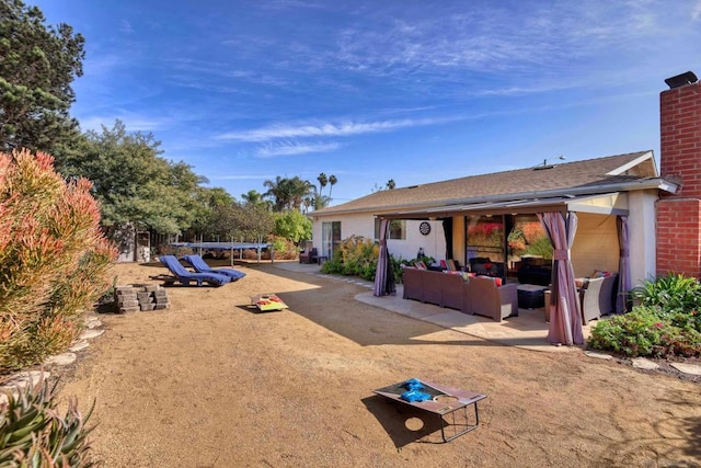 view of yard with a patio, outdoor lounge area, and a trampoline