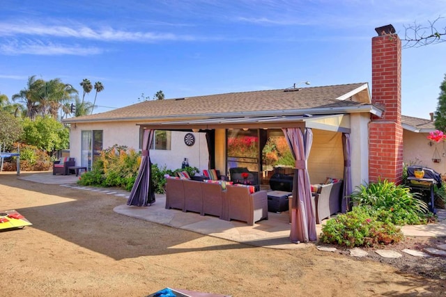 view of front of property featuring an outdoor living space and a patio area