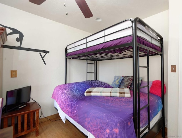 bedroom with wood-type flooring and ceiling fan