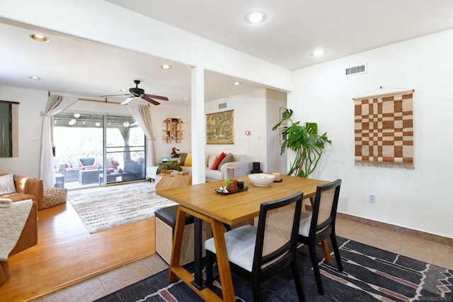 tiled dining area featuring ceiling fan