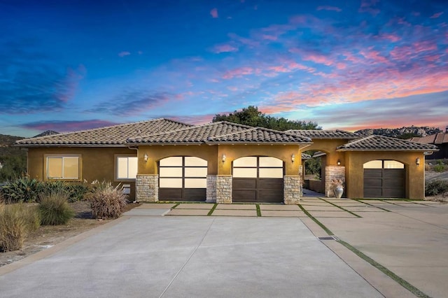 mediterranean / spanish-style home featuring a garage