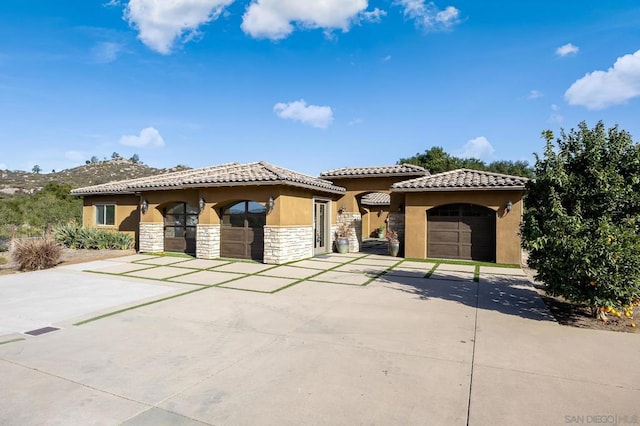 mediterranean / spanish-style home featuring a garage