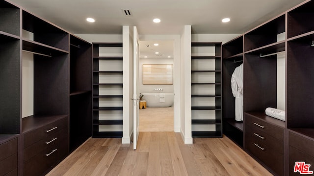 walk in closet featuring light hardwood / wood-style floors