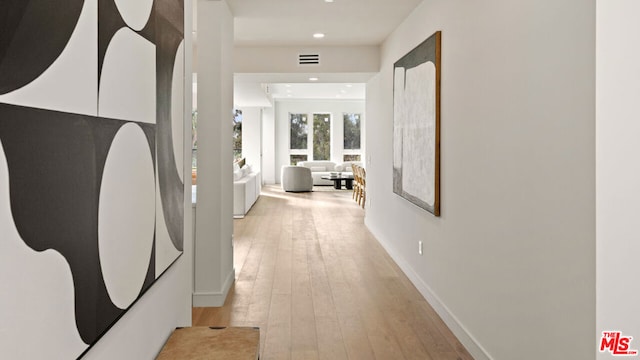 hallway with light hardwood / wood-style floors