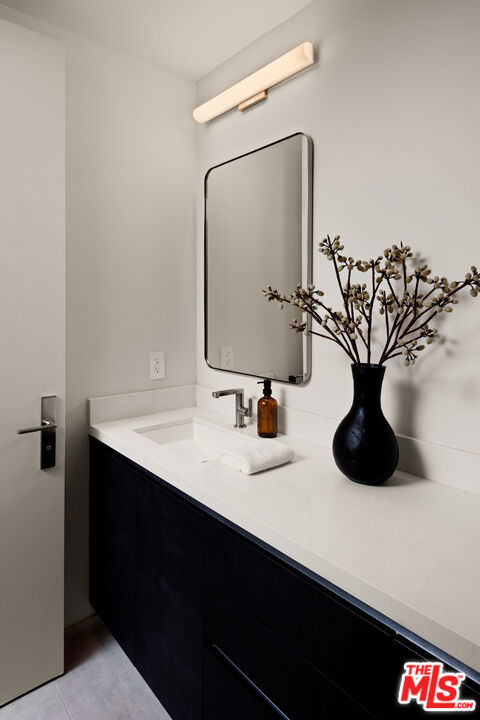 bathroom with tile patterned floors and vanity