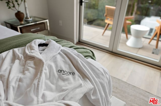 bedroom featuring hardwood / wood-style flooring and access to outside