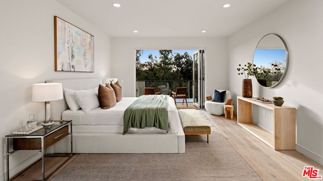 bedroom featuring access to outside and light hardwood / wood-style floors