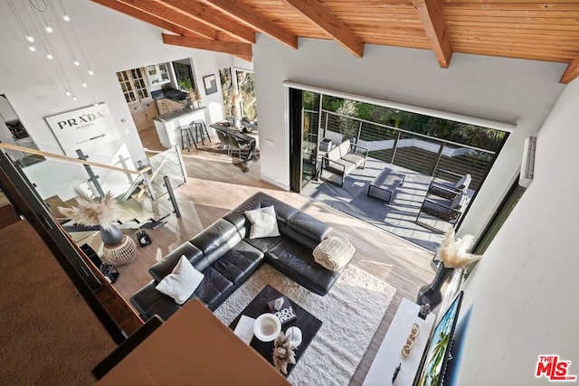 living room with wood ceiling, high vaulted ceiling, and beamed ceiling