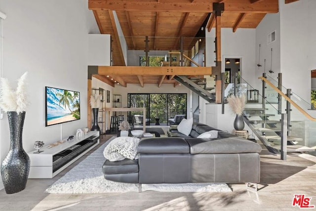 living room with beamed ceiling, wooden ceiling, and high vaulted ceiling