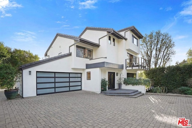 view of front of home with a balcony and a garage