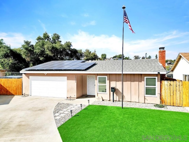 ranch-style house with a garage, a front lawn, and solar panels