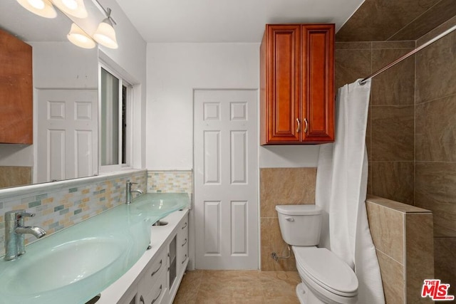 bathroom with vanity, tasteful backsplash, a shower with curtain, tile patterned floors, and toilet