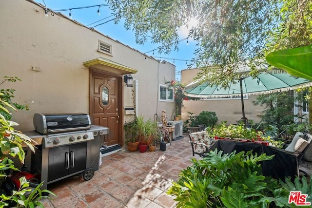 view of patio with area for grilling and central air condition unit