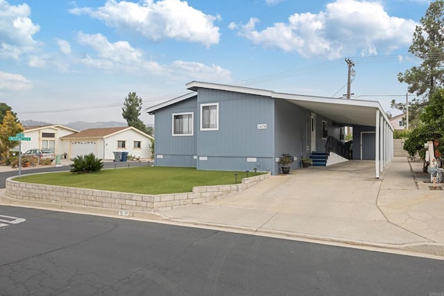 view of front facade with a carport and a front yard