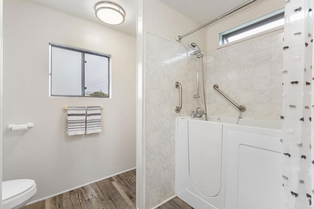 bathroom with wood-type flooring, independent shower and bath, and toilet