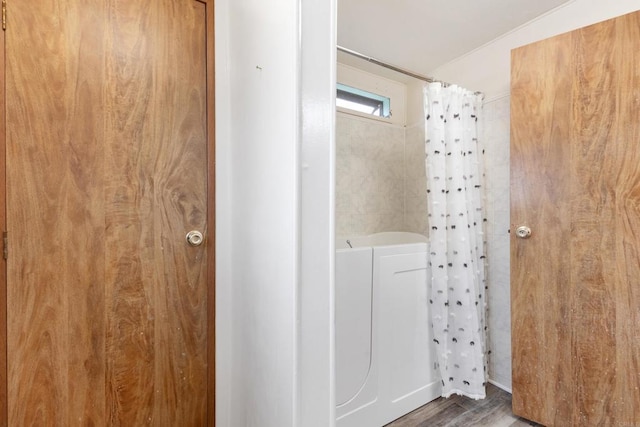 bathroom with hardwood / wood-style floors and curtained shower