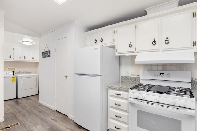 kitchen featuring white appliances, light hardwood / wood-style flooring, white cabinets, washing machine and clothes dryer, and vaulted ceiling