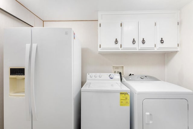 laundry room featuring cabinets and separate washer and dryer