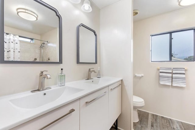 bathroom with vanity, hardwood / wood-style floors, a shower with curtain, and toilet