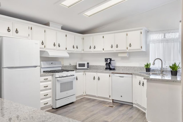 kitchen featuring lofted ceiling, sink, white appliances, light stone countertops, and white cabinets