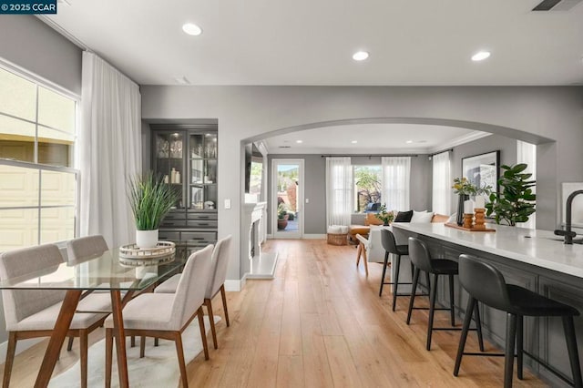 dining room featuring crown molding and light hardwood / wood-style floors