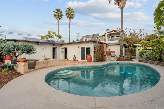 back of property featuring a patio and solar panels