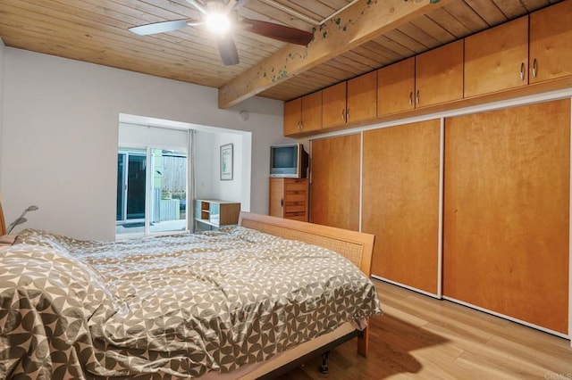 bedroom featuring wood ceiling, ceiling fan, light hardwood / wood-style floors, beam ceiling, and a closet