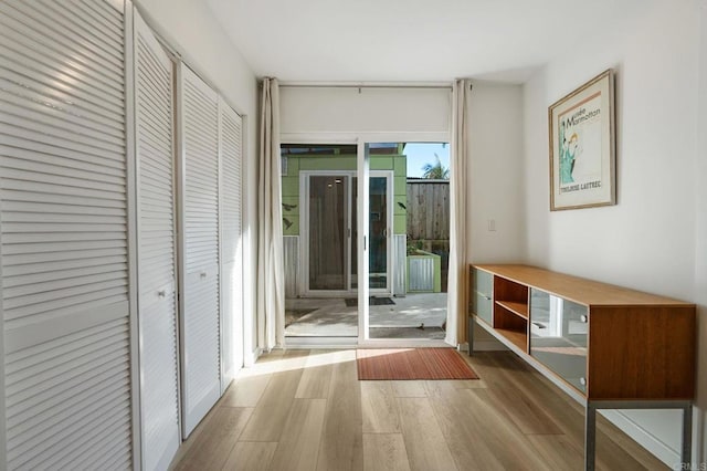 hallway with light hardwood / wood-style flooring