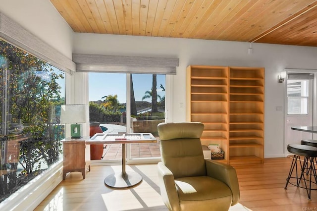 sitting room with a wealth of natural light, wood ceiling, and light hardwood / wood-style floors