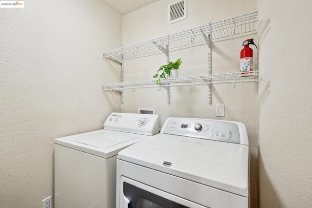 laundry room with independent washer and dryer