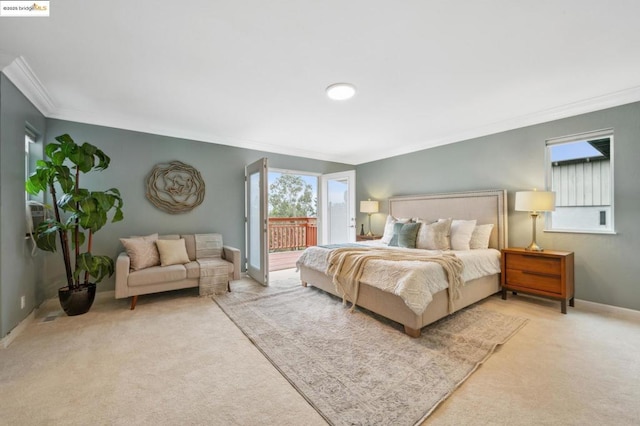 carpeted bedroom with ornamental molding and access to outside