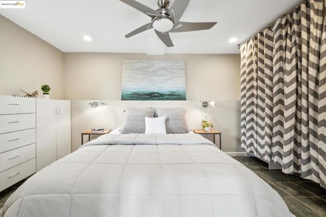 tiled bedroom featuring ceiling fan