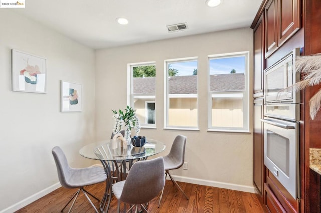 dining space with hardwood / wood-style flooring and plenty of natural light