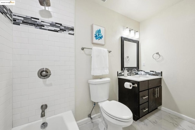 full bathroom featuring tiled shower / bath, vanity, and toilet