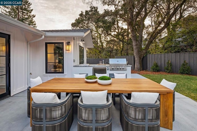 view of patio with an outdoor kitchen and a grill