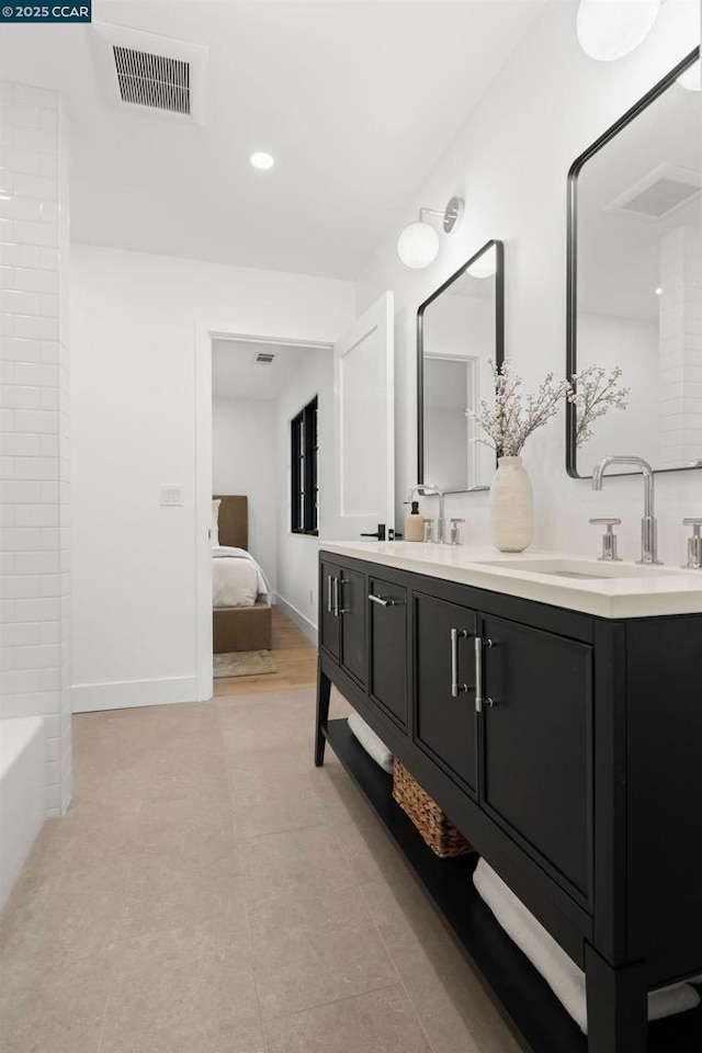 bathroom featuring vanity, tile patterned flooring, and bathtub / shower combination