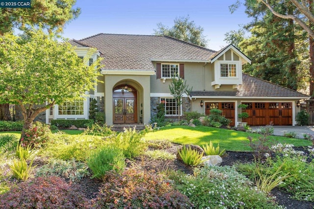 view of front of home featuring a front yard and french doors