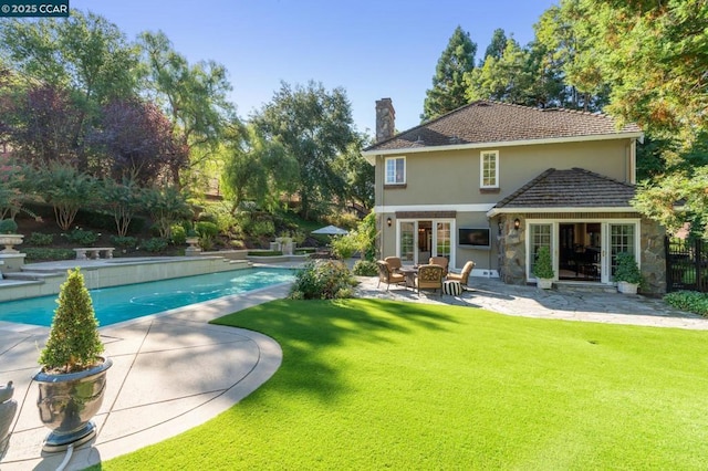 view of swimming pool featuring a patio area and a lawn